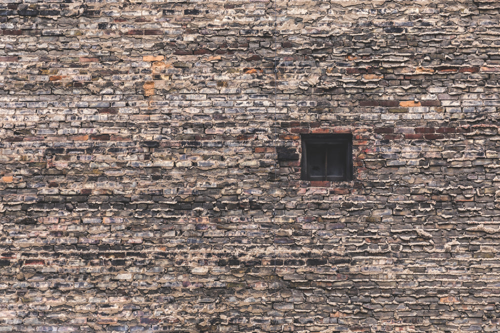 single window in large brick wall