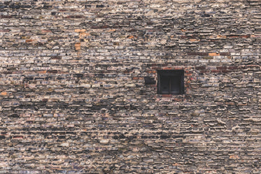 single window in large brick wall