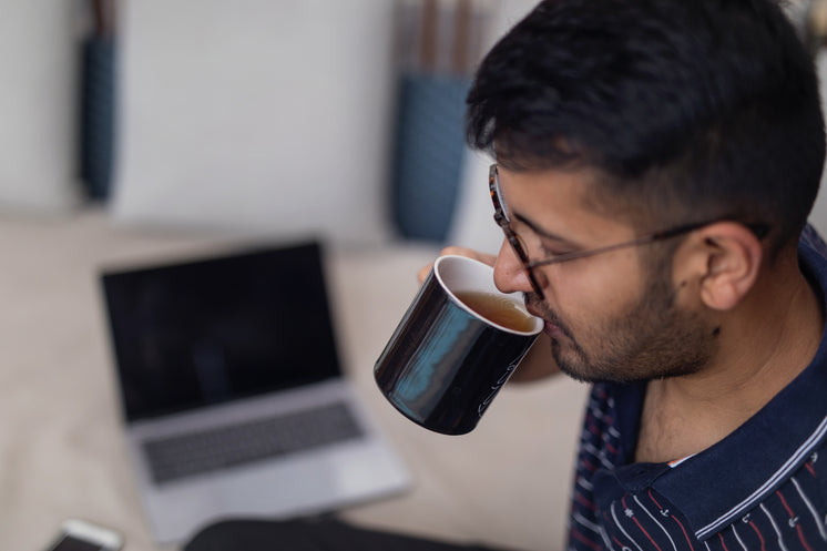 Sipping Tea In Modern Workspace