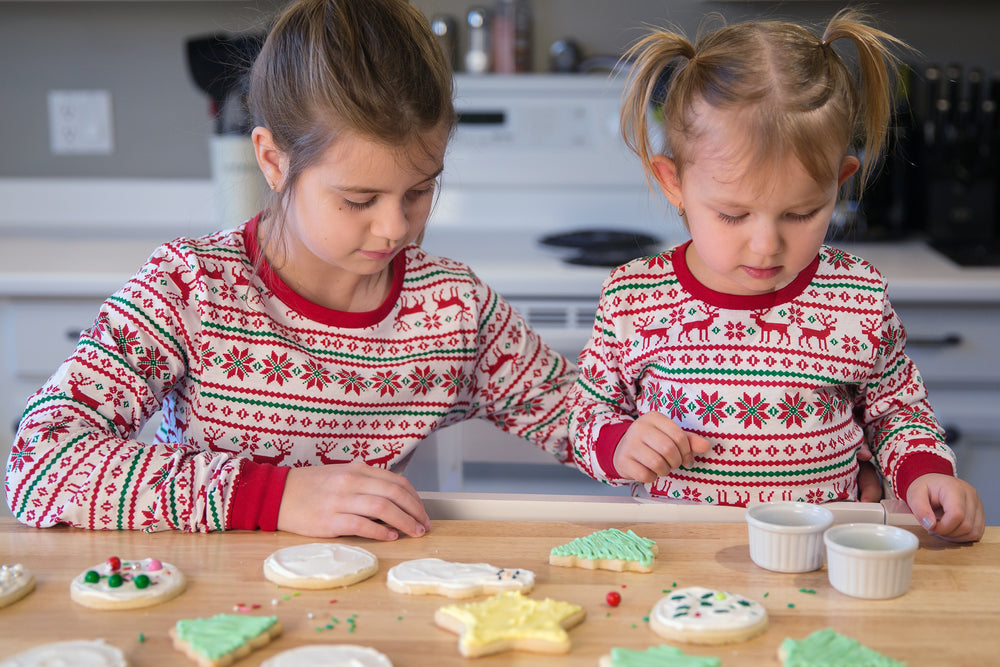 sisters decide what sprinkles to decorate with