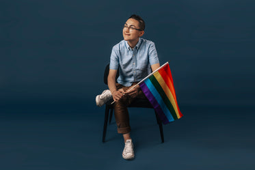 sitting holding pride flag