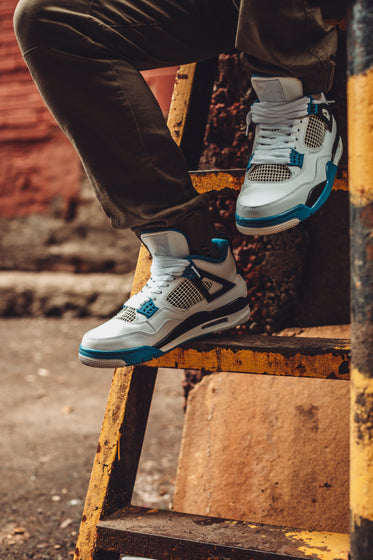 sitting on ladder wearing sneakers