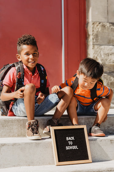 sitting on school steps to go back to school