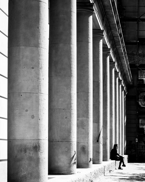 sitting under stone columns