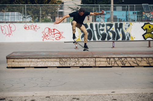skateboarder doing an ollie onto grind box