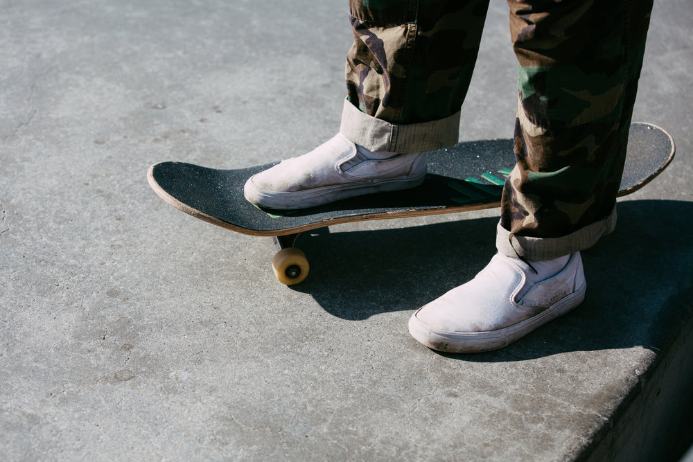 skater standing with one foot on the board