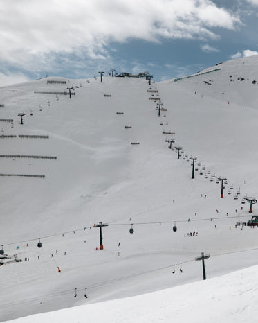 ski lifts making their way up a mountain