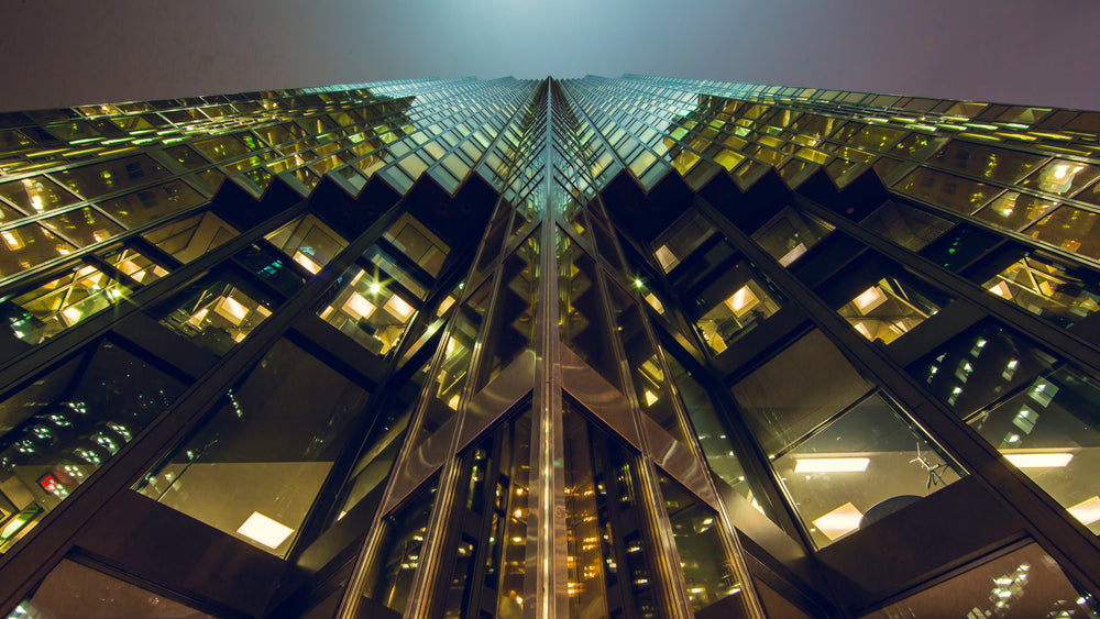 looking up at a skyscraper at night