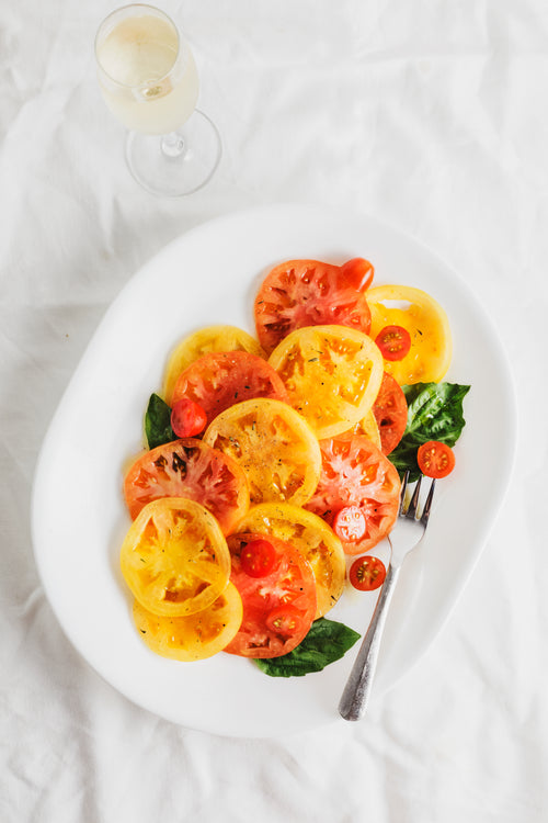 sliced tomatoes and basil with white wine