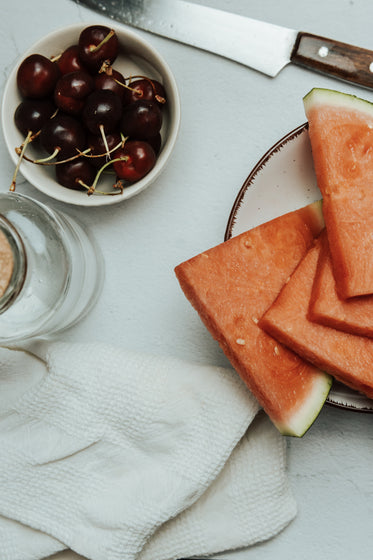 sliced watermelon and ripe cherries