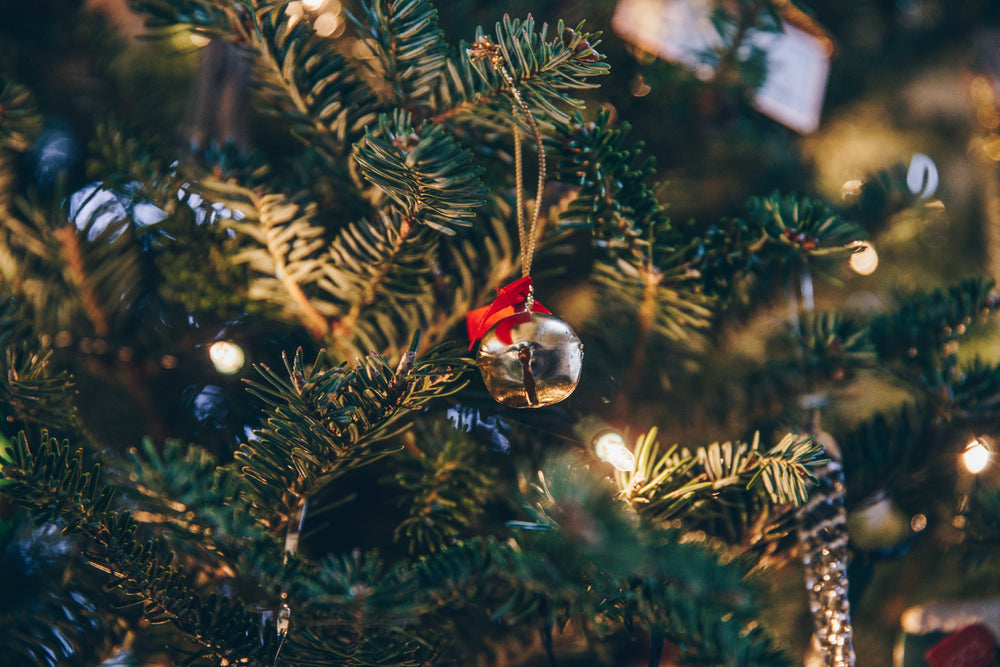 small bell ornament on tree