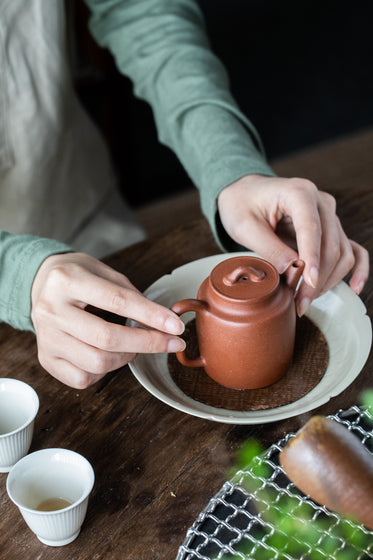 small brown teapot with white teacups