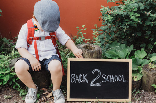 small child with back to school sign