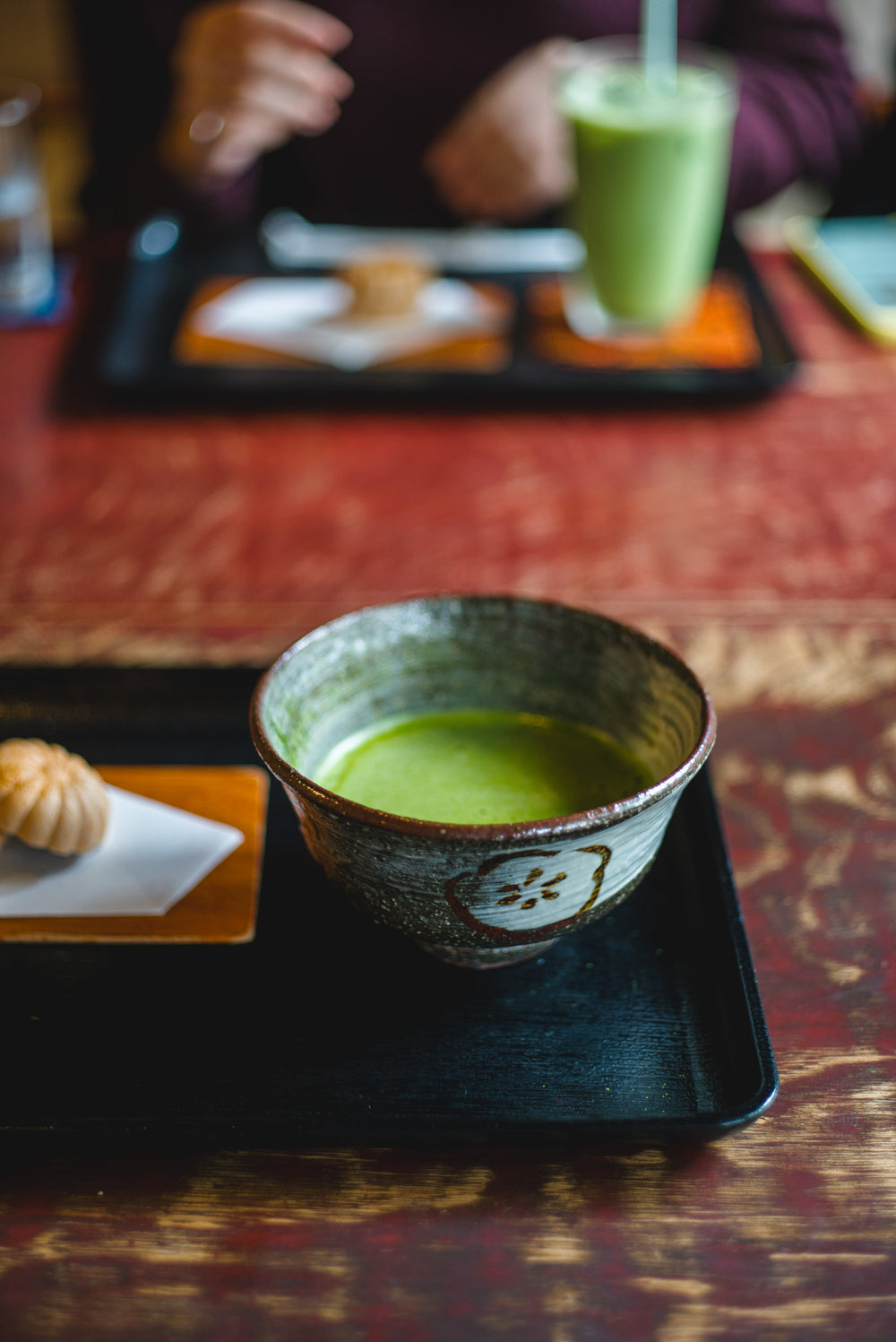 small down with vibrant green liquid sits on a black tray