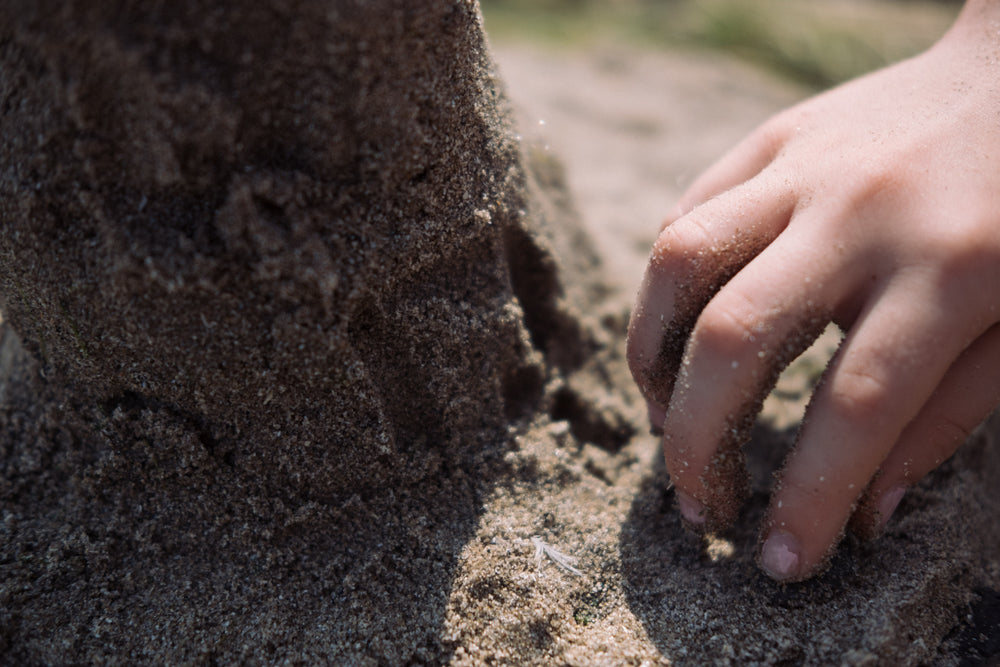 small hand in the sand