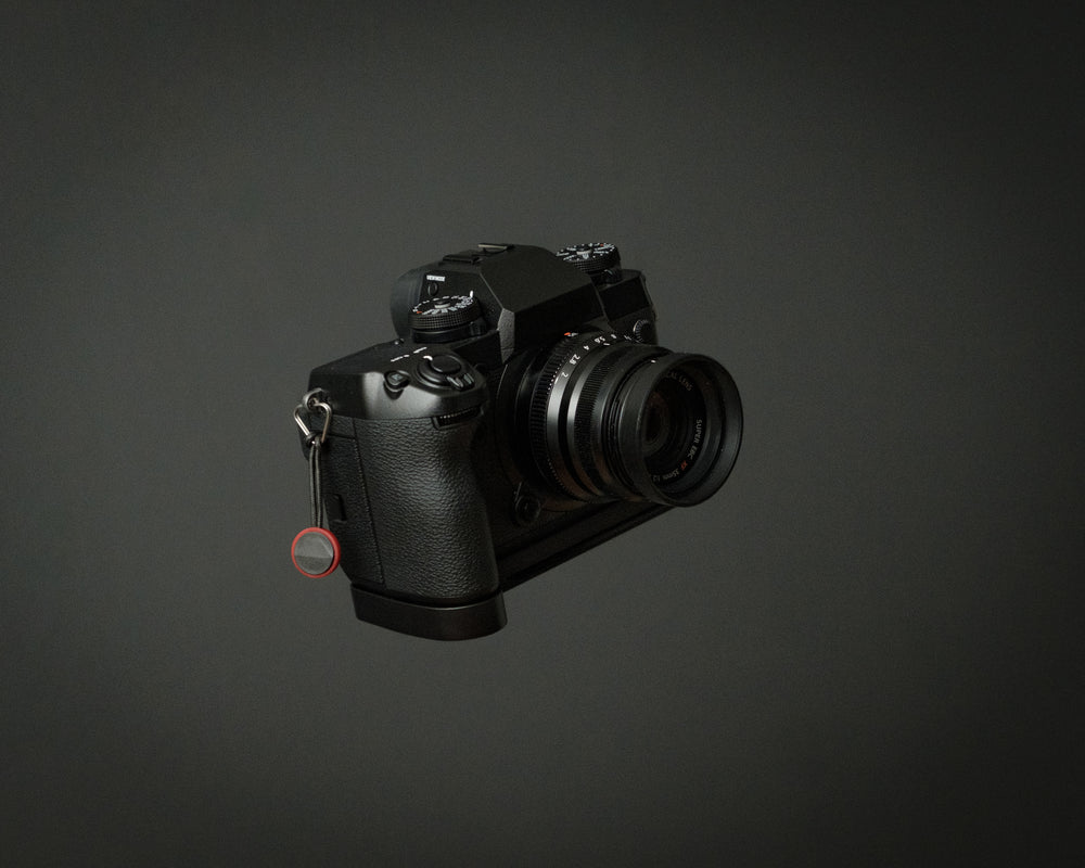 small mirrorless camera on grey background