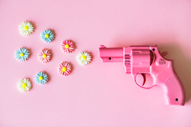 small pink revolver shooting flowers