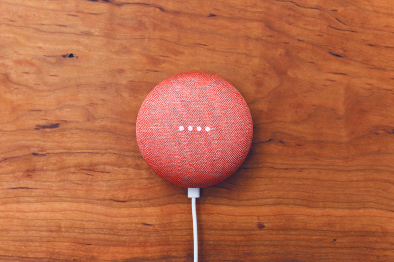 a red and white cake pops pops pops - smart home device on wooden desk