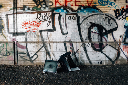 smashed tv and graffitied wall
