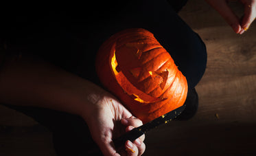 smiling jack o lantern in woman's lap