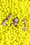 smiling senior in yellow ball pit