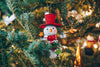 smiling snowman ornament on tree