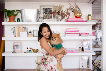 smiling woman hugging her dog