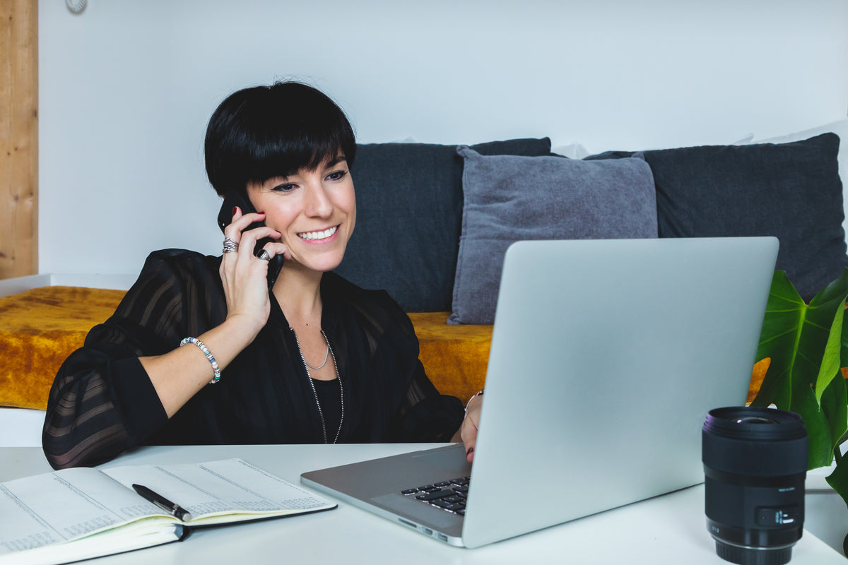 smiling women at her laptop working