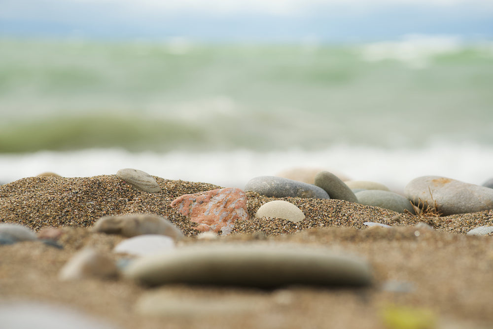 smooth rocks on sandy beach