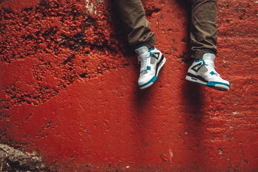 sneakers in front of red wall