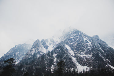 snow capped mountains covered with clouds