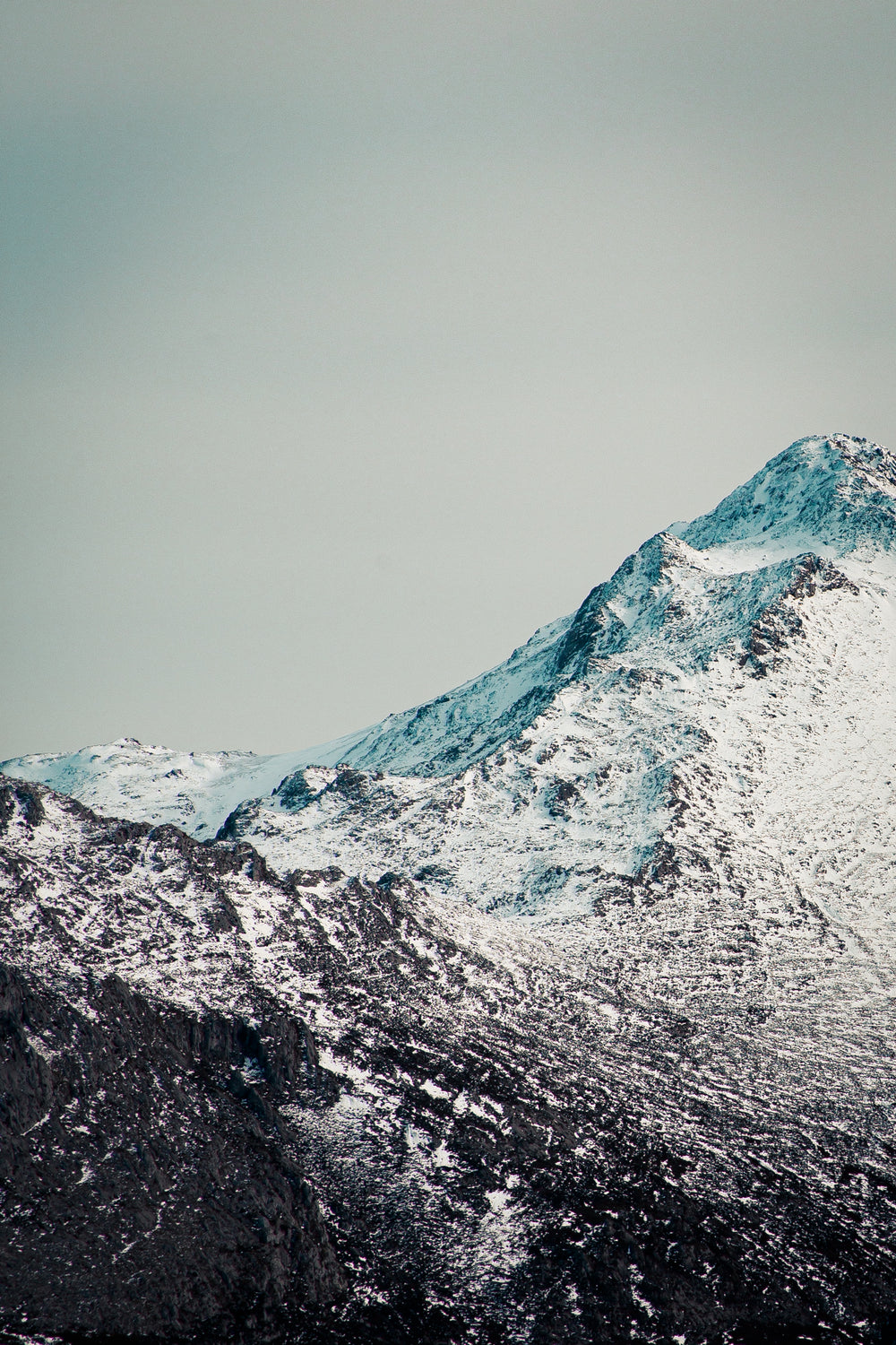 snow covered black rocked peaks