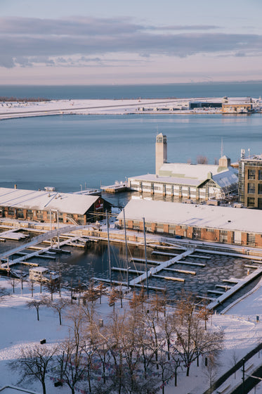 snow covered rooftops and an empty harbor