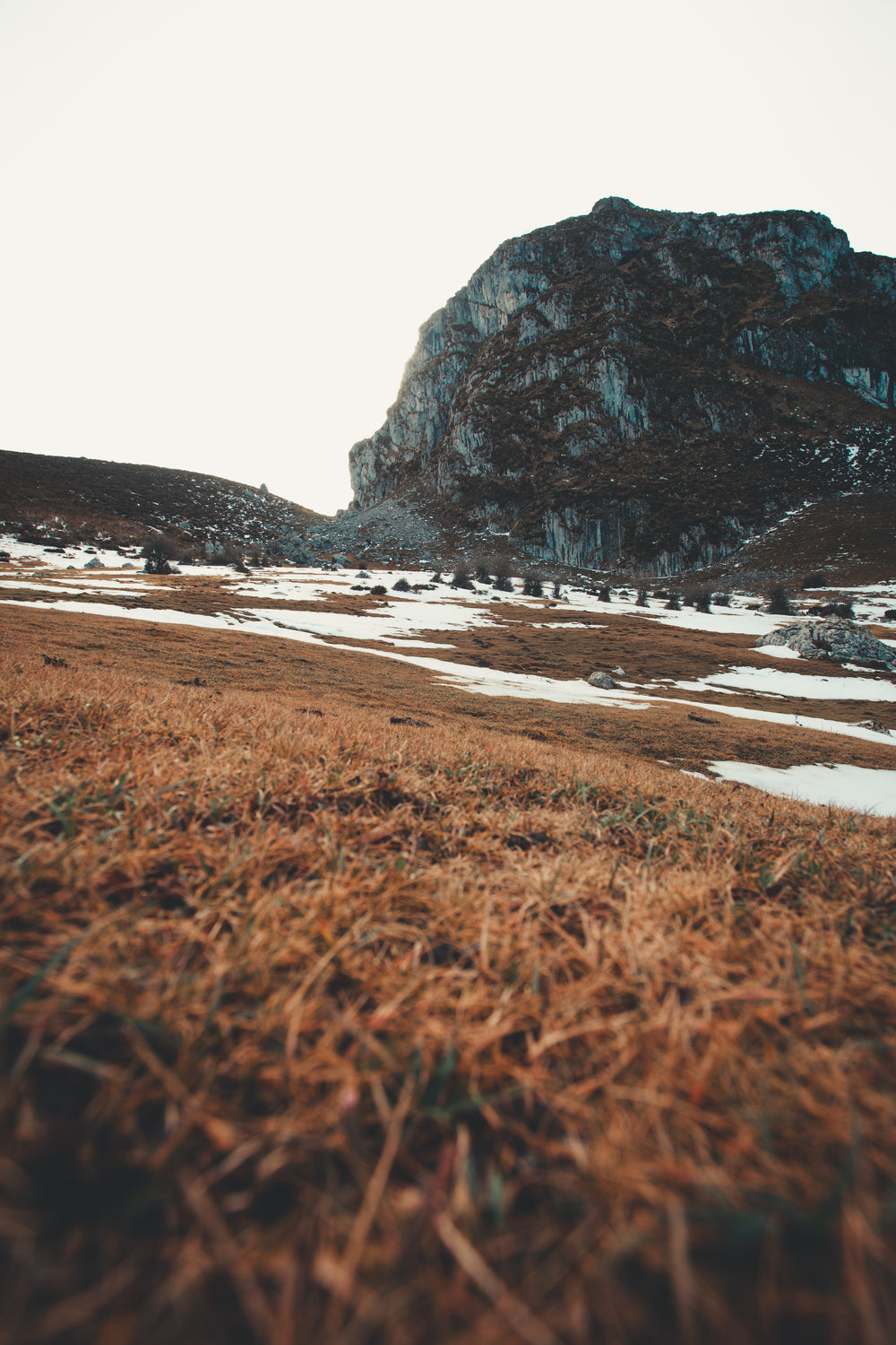 snowy landscape under rock face