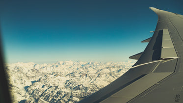 snowy peaks from aircraft window