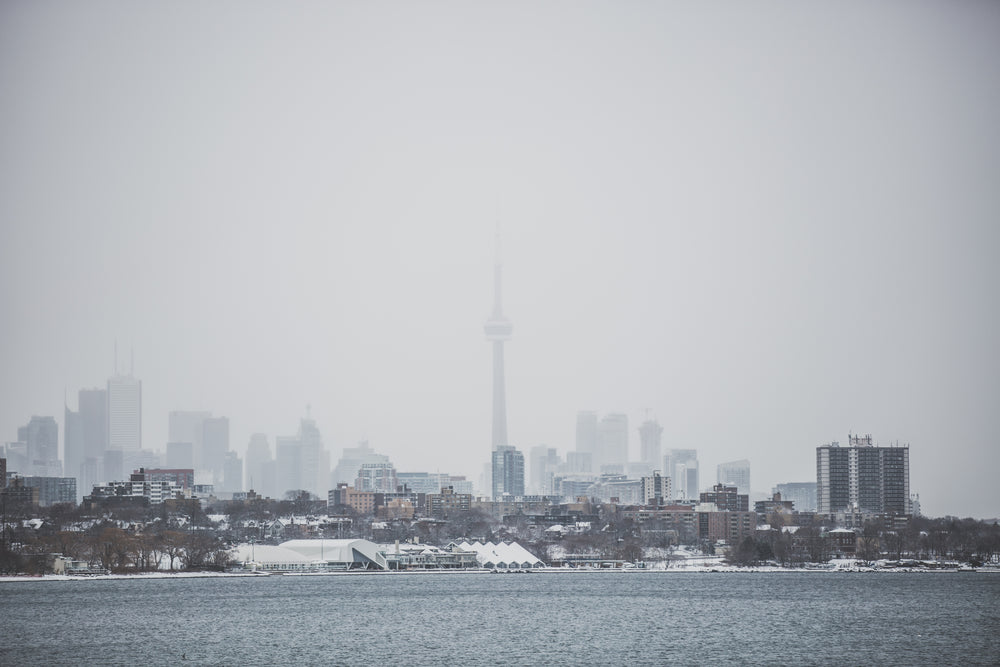 snowy toronto skyline over water