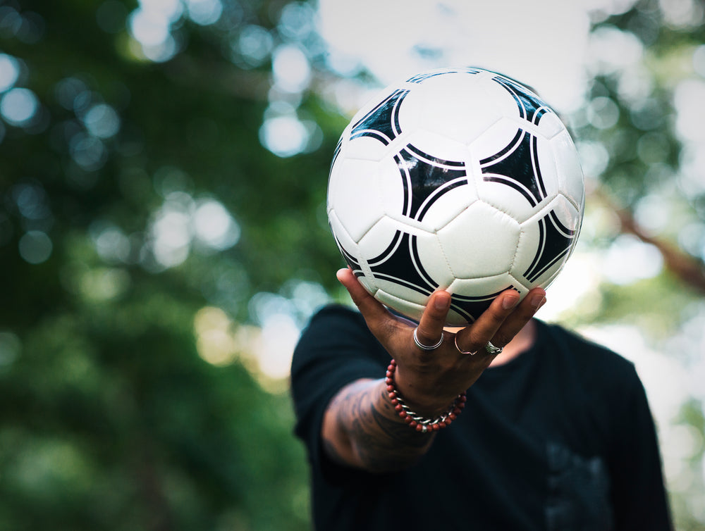 soccer ball in hand at park