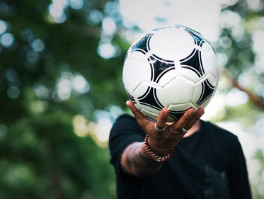 soccer ball in hand at park