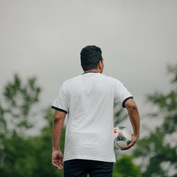 Soccer Player Holding Ball Looking Out