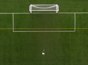 soccer player in penalty kick position drone view