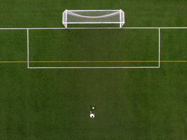 soccer player in penalty kick position drone view