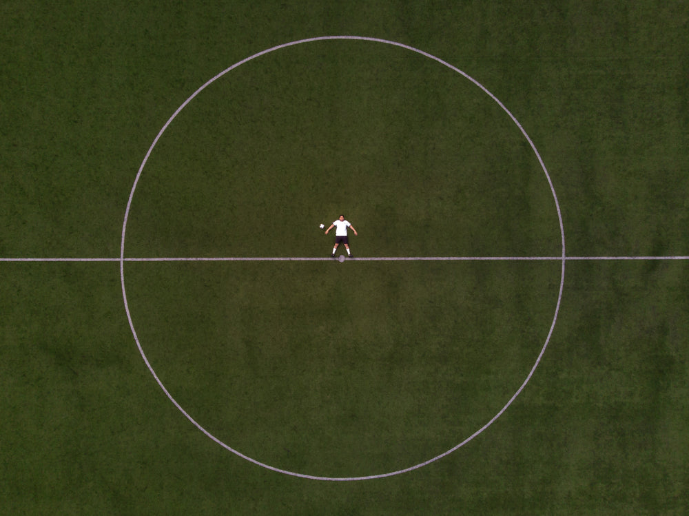 soccer player laying in the center circle