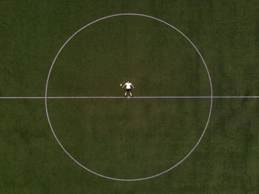soccer player laying in the center circle