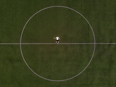 soccer player laying in the center circle