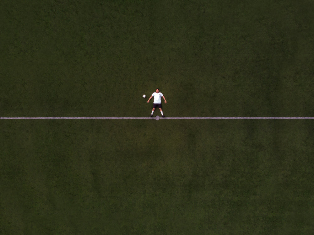 soccer player laying in the center line