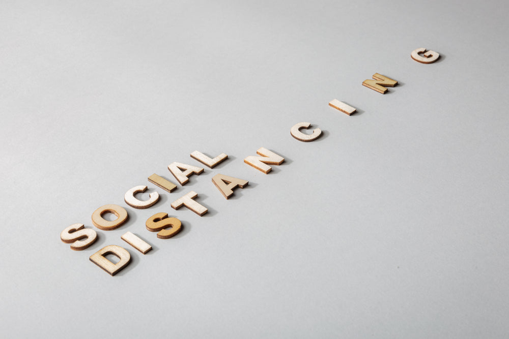 social distancing in wooden lettering