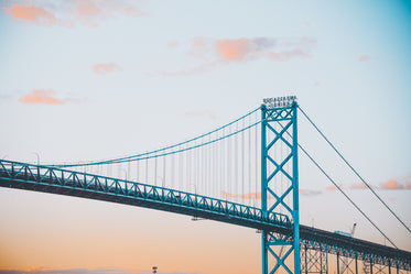 soft and colorful sunrise over a metal bridge