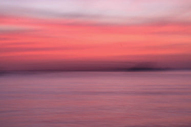 soft gradient of sunset over water