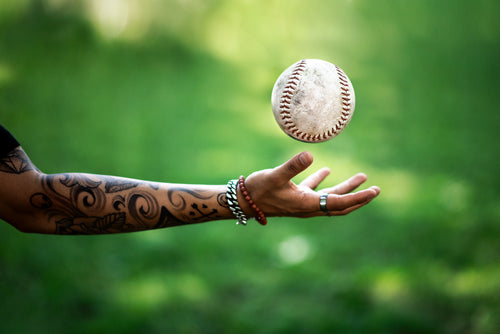 softball flies above hand