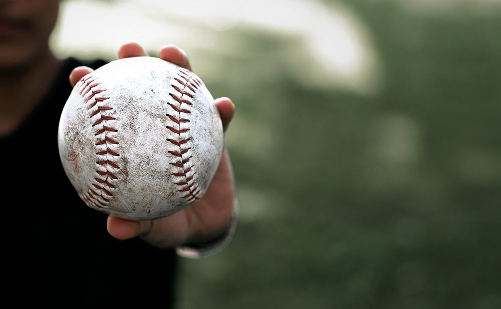 softball in palm held to camera